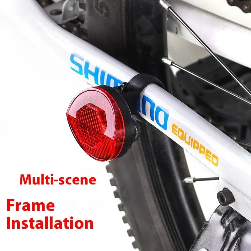 Red plastic anti-theft bicycle taillight bracket mounted on seat post with reflective surface