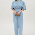 Blue two-piece polyester men's suit with long-sleeve jacket and trousers on a hanger.