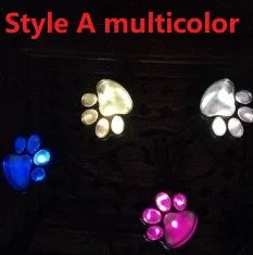 Black solar powered animal paw print garden lights with four paw shapes connected to solar panel