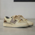 Beige low-top skateboard shoes with microfiber upper and flat rubber sole on white background