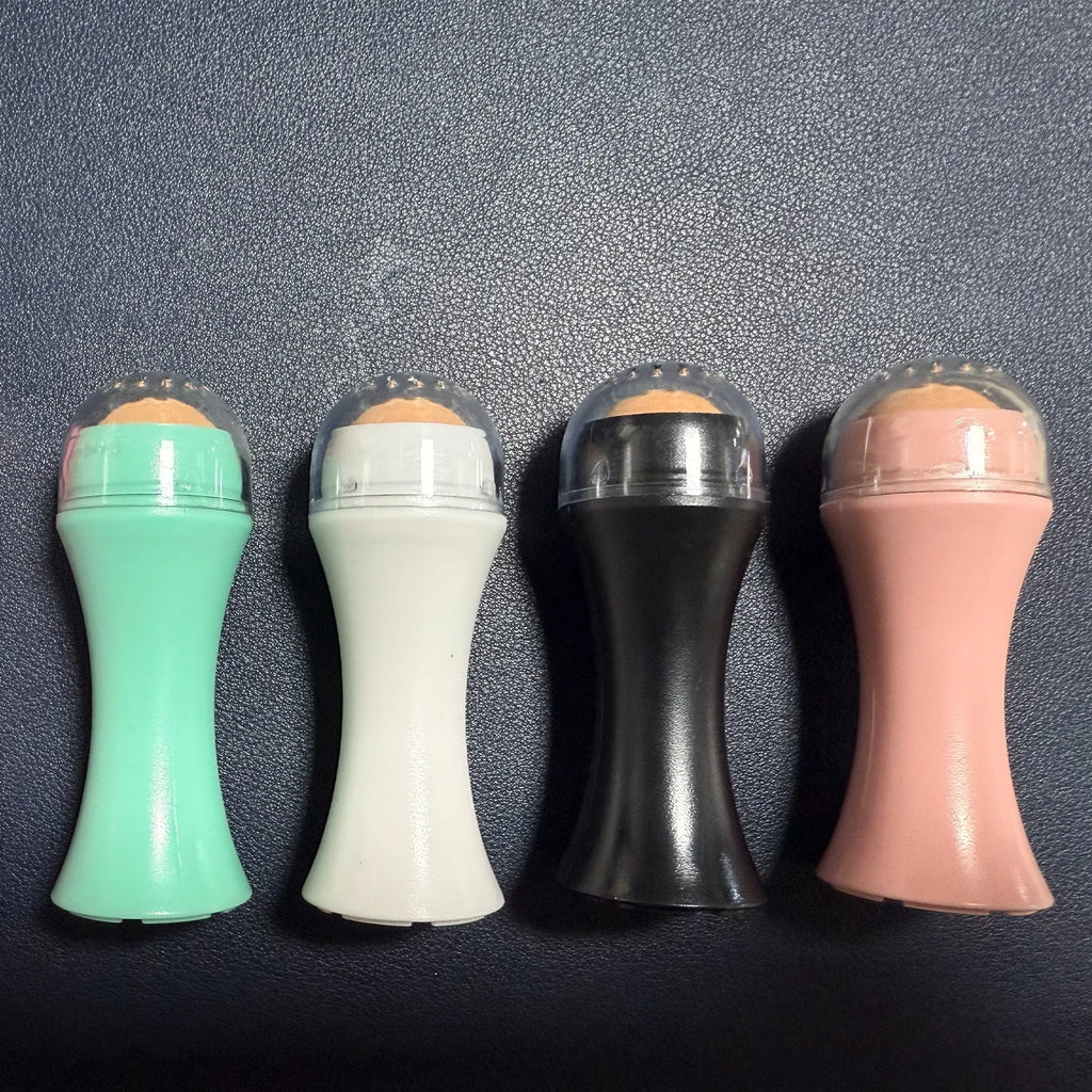 Volcanic stone portable roller for oily skin control in black, green, pink, or white.