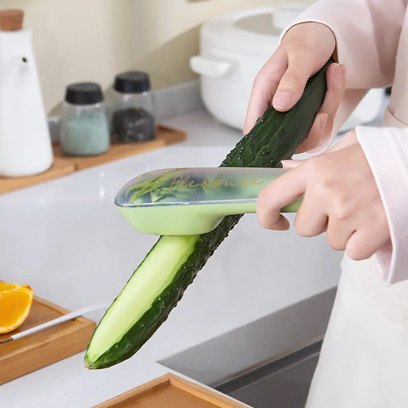 Dark green peeling knife with a storage tube and stainless steel blade on a kitchen worktop.