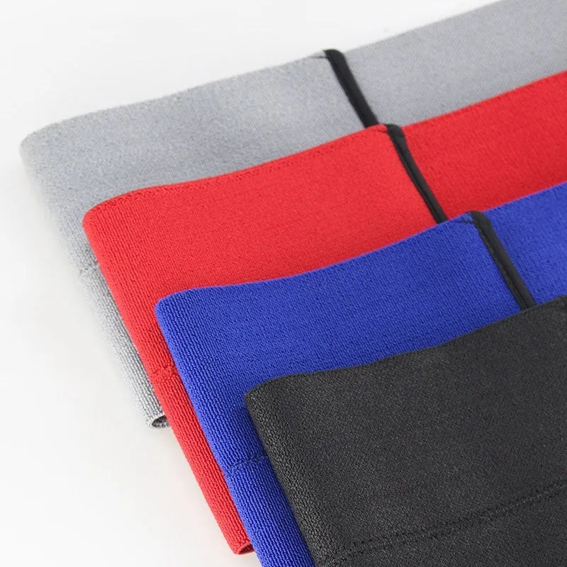 Black elastic elbow support compression sleeve worn on an arm.
