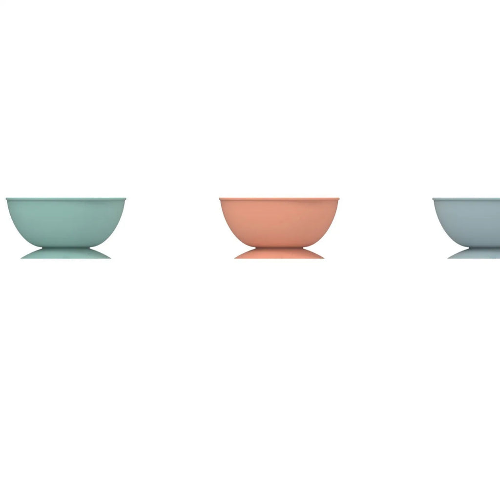 Cyan silicone pet licking mat bowl with suction cup base on a smooth surface