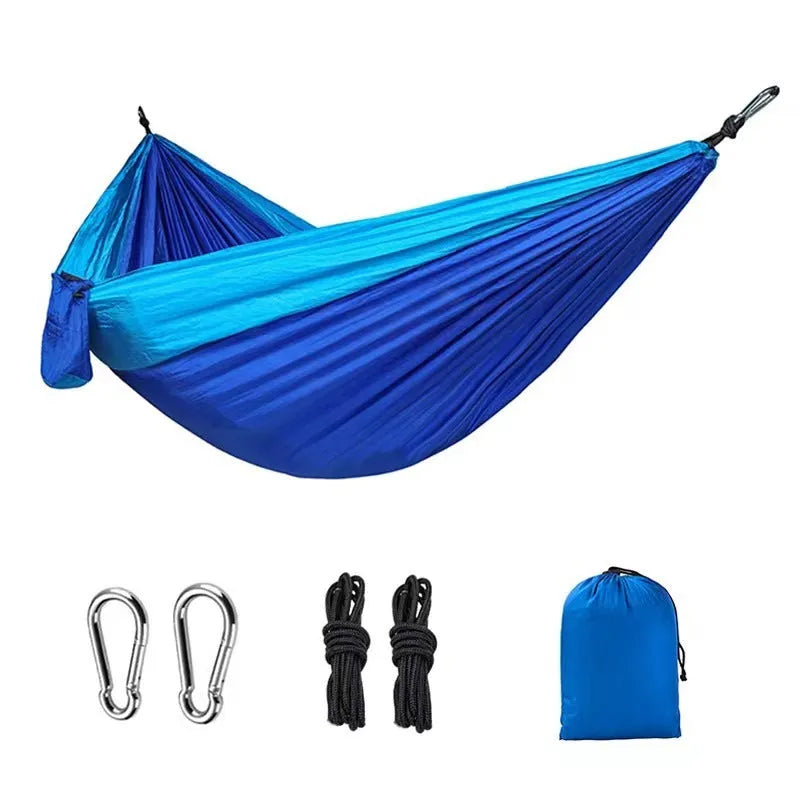 Blue parachute nylon outdoor hammock hung between trees, showing its 270cm length.