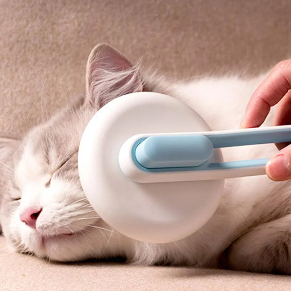 Automatic pet grooming brush with stainless steel pins in blue, green, or pink, showing the handle grip and release button.