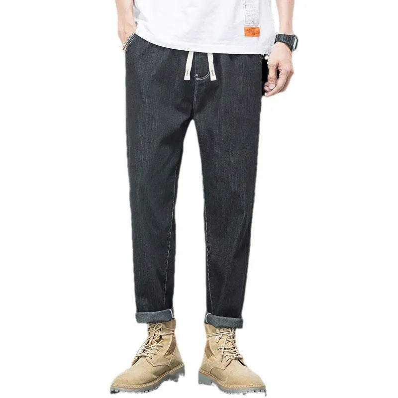Men's loose plus size elastic waist jeans in blue cotton denim with mid waist straight leg fit