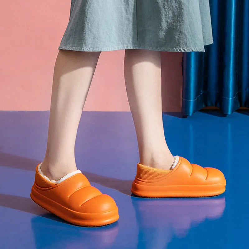 Women's waterproof EVA slippers in various colours with plush lining and a non-slip flat sole.