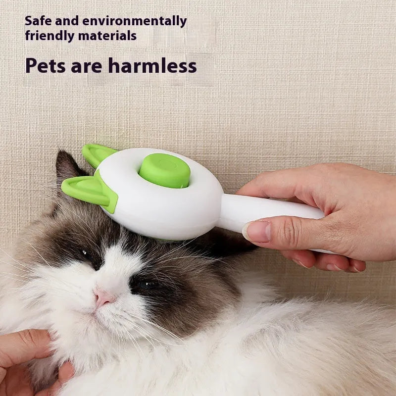 Greenish white cat grooming brush with stainless steel teeth and a self-cleaning button on the handle.