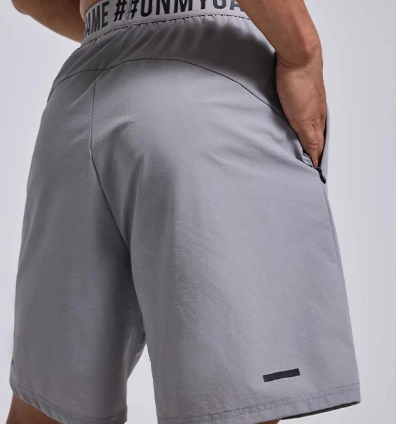 Men's black breathable sports shorts with letter detail and elastic waist.