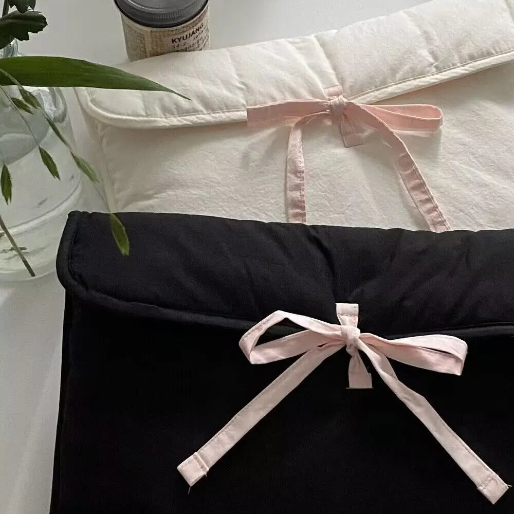 Women's black and white quilted nylon computer bag with striped pattern and bow detail