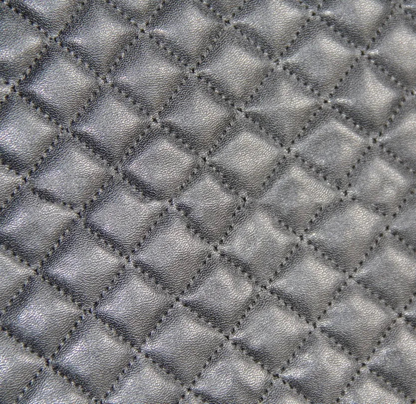 Black quilted automotive seat cover made of PU and polyester fabric, shown with plastic attachment hooks.