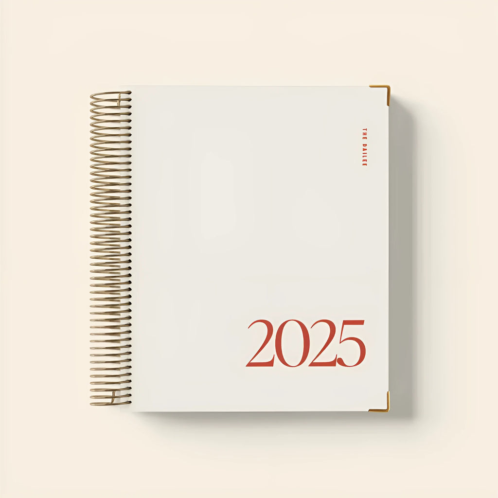 Cherry red wire-bound coil notebook with daily schedule pages open flat