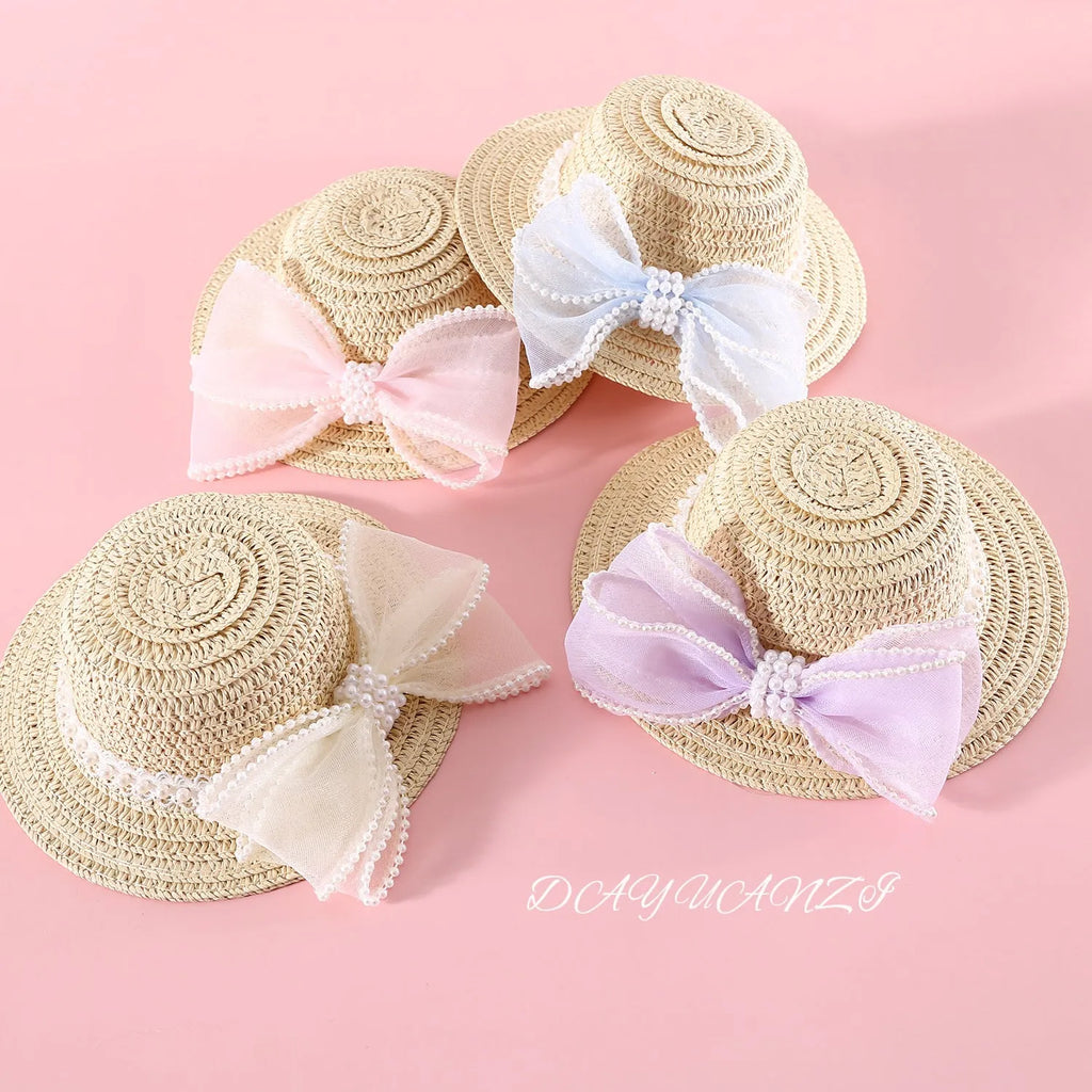 Woven straw hat with pearl bow decoration for cats, available in four colours and two sizes