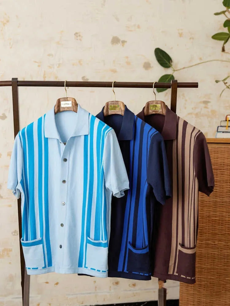 A royal blue striped lapel cardigan polo shirt on a hanger, showing short sleeves and knitted fabric.