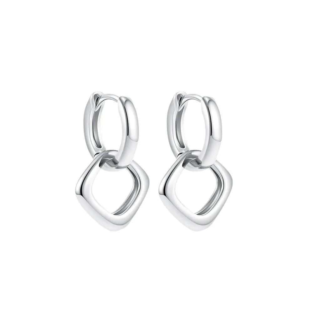 Double ring twist geometric square ear clip simple copper earrings on a neutral background