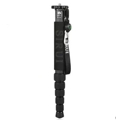 Black carbon fibre telescopic camera monopod fully extended next to a DSLR.