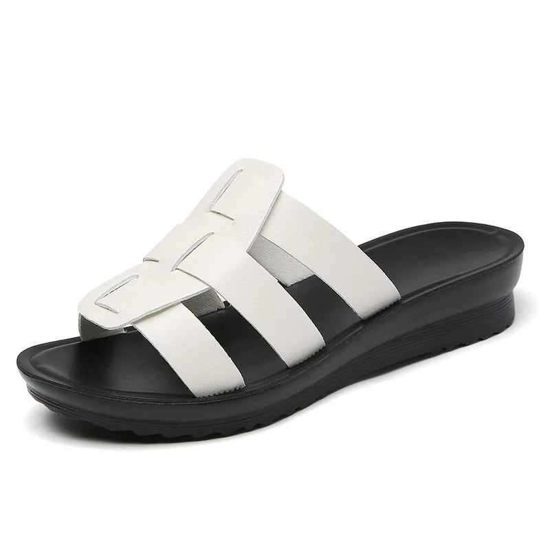 Beige waxed leather women's flat-bottom slippers in a large size on a white background
