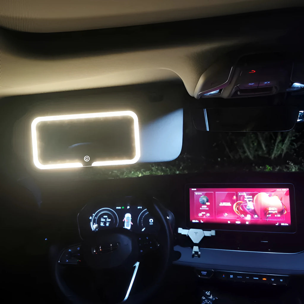 White car sun visor with rectangular LED-lit make-up mirror mounted on it.