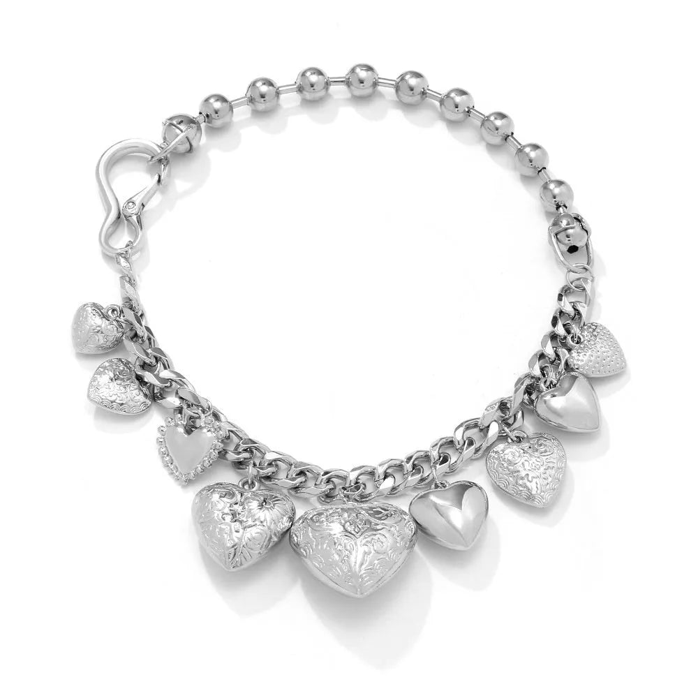 Exaggerated style gold heart pendant necklace with a regular chain on a plain background.