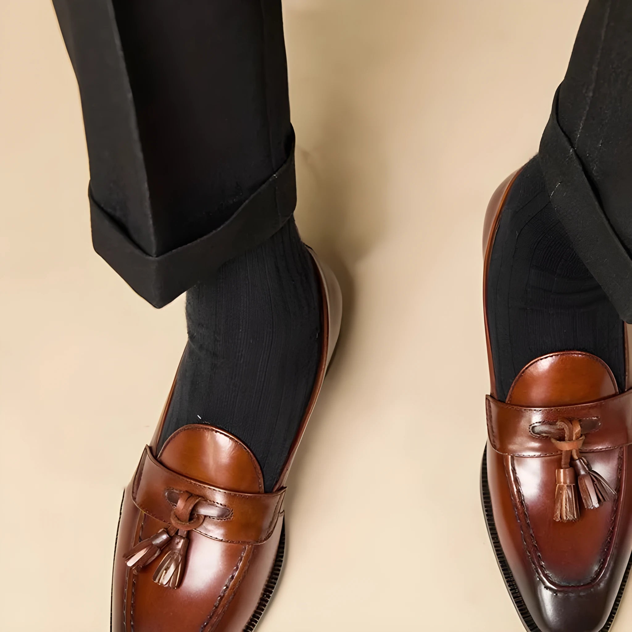 Men's black polished leather tassel loafers with rubber soles for business casual wear