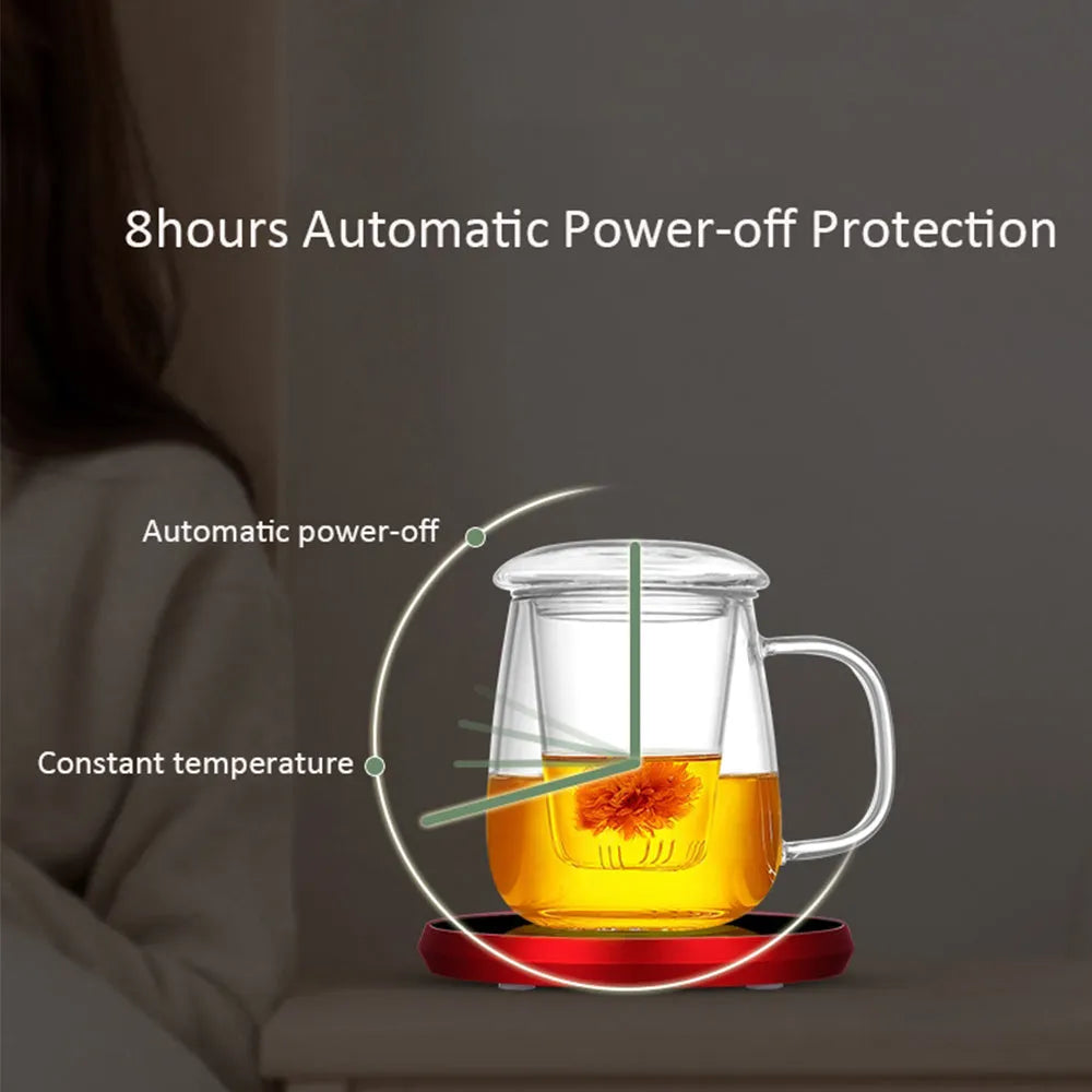 Black USB-powered beverage warming coaster with tempered glass top on a wooden desk