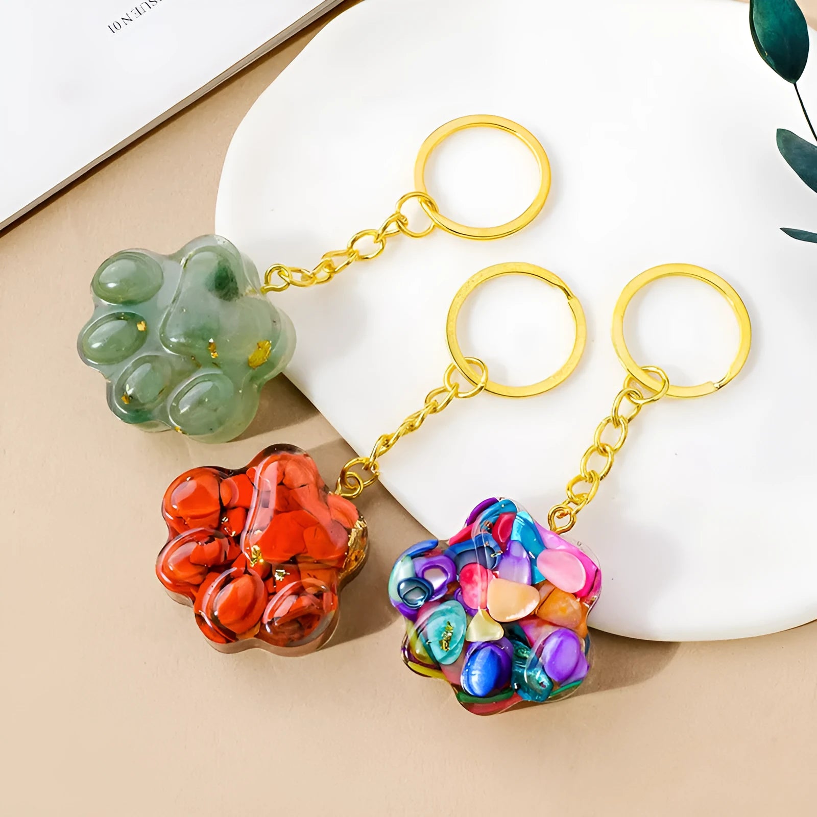 Small natural crystal cat's paw shaped keychain pendant on a keyring.