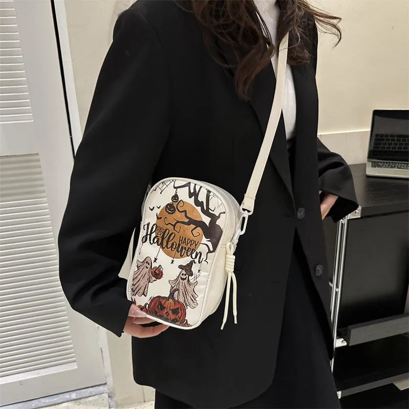 Halloween graffiti print mini crossbody bag with cartoon pumpkin ghost bat design in multiple colours.