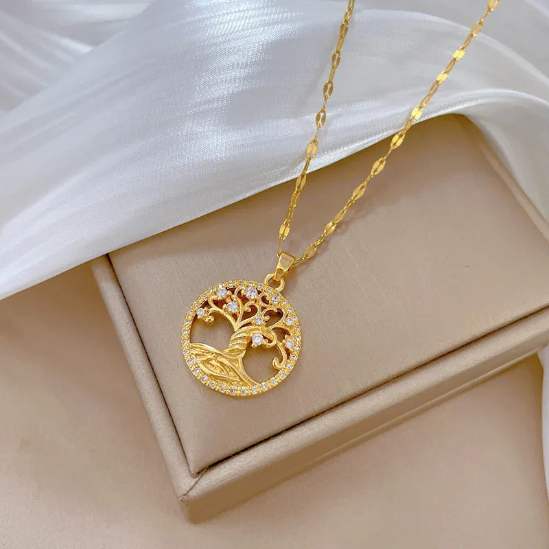 Gold-plated lucky tree pendant necklace with rhinestone zircons and mother of pearl on an adjustable chain.
