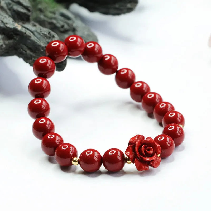 Close-up of a women's natural cinnabar bracelet with a detailed 8mm purple gold sand rose centrepiece.