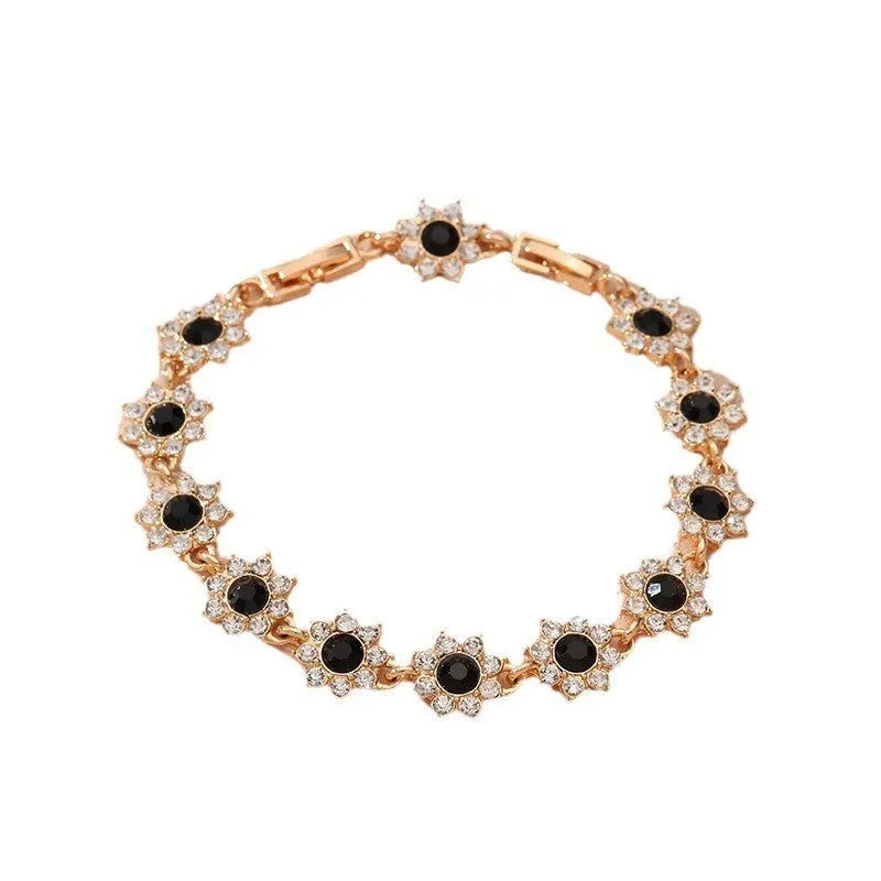 Coloured gemstone bracelet with flower-shaped design in gold and silver colour variations