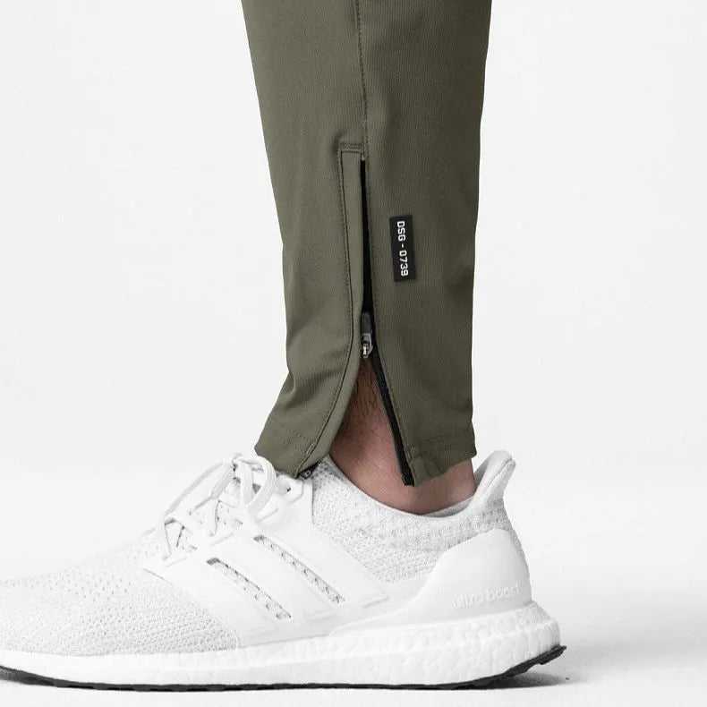 Men's loose grey ankle-tied fitness pants with a casual cut for running and gym workouts.