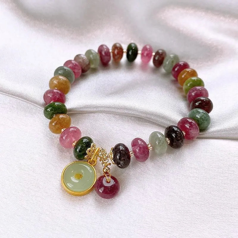 Colourful tourmaline abacus bead bracelet with rabbit pendant charm on wrist