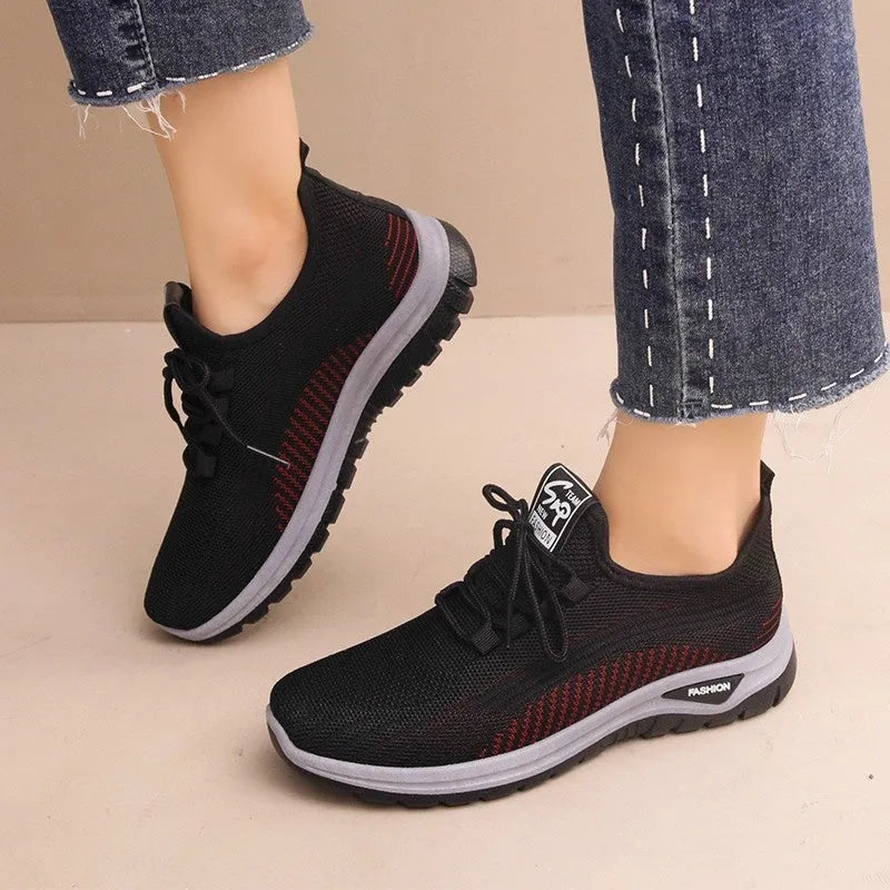 Women's mesh breathable casual sneakers in black with cross strap design and round toe