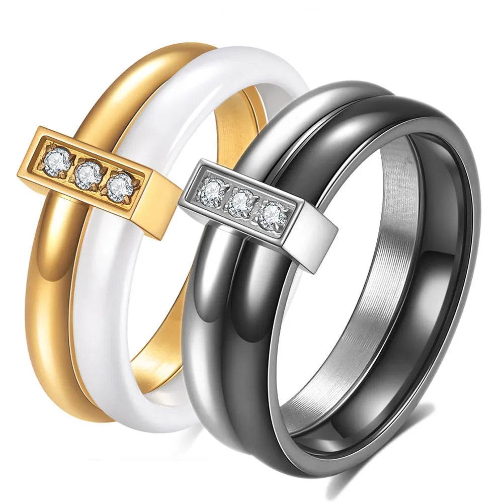 Glossy black ceramic women's ring with geometric shape and inlaid zirconium details on a finger.