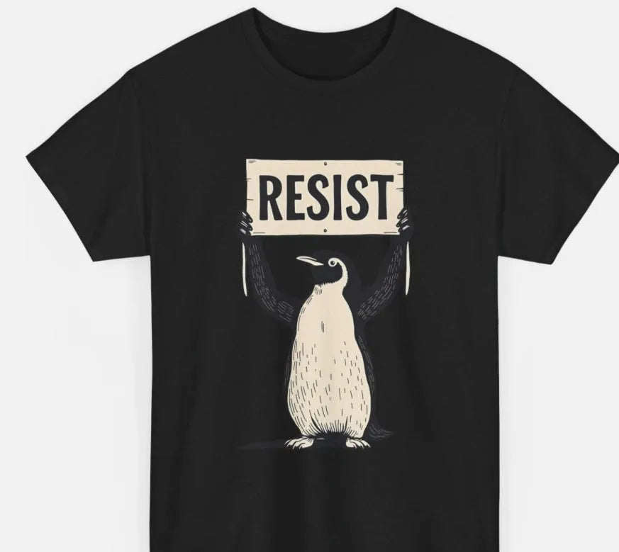 Straight-cut loose cotton T-shirt in black on a hanger, showing short sleeves and round neck.