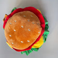 Cat wearing burger-shaped fabric headdress collar with adjustable fastening