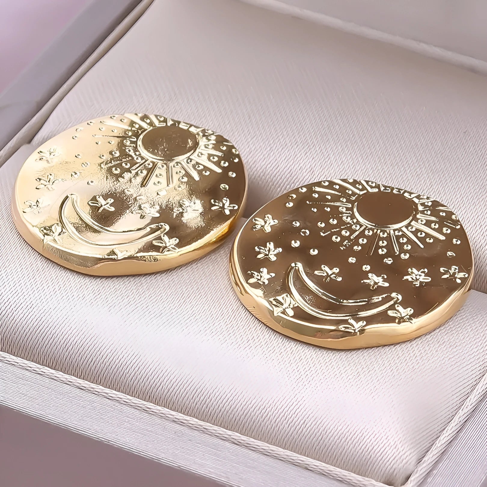 Stainless steel stud earrings with geometric shell design in gold and silver finishes