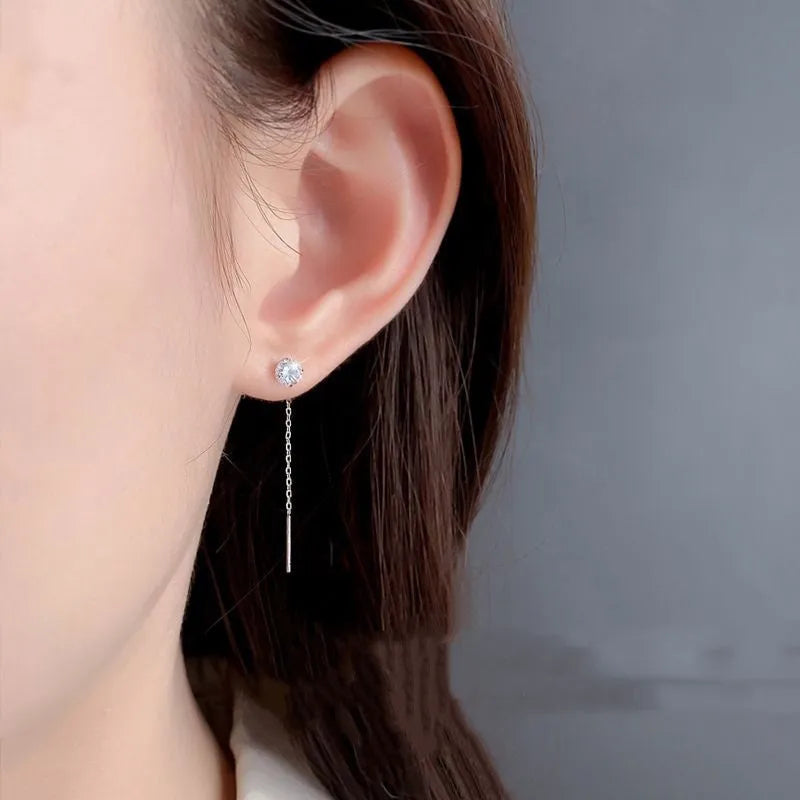 Round zirconium stud earrings with tassel rhinestone hanging in white gold colour on a geometric silver base