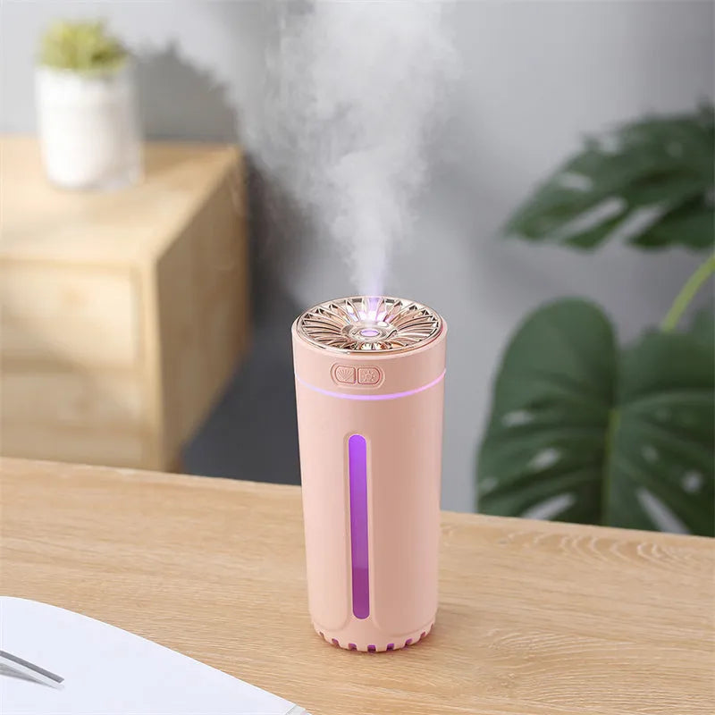 Black portable USB rechargeable humidifier with colourful LED lights on a car cup holder
