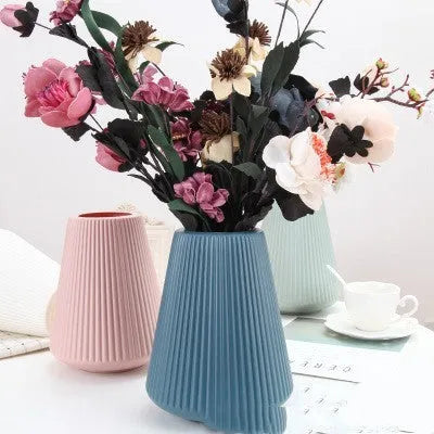Blue melamine plastic decorative flower vase measuring 16cm by 20cm on a desktop