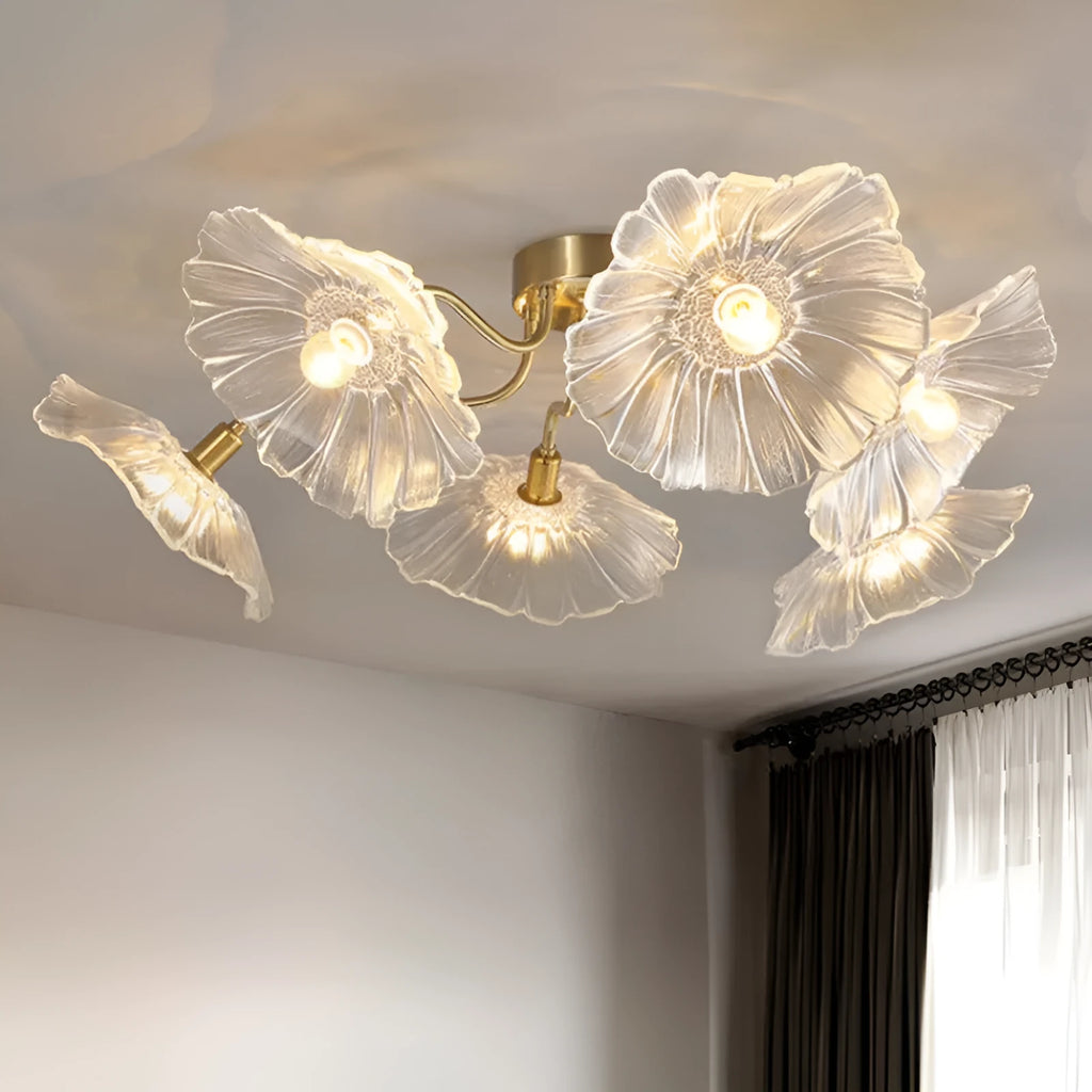 Modern white flower-shaped ceiling lamp with multiple heads and remote control on a table.