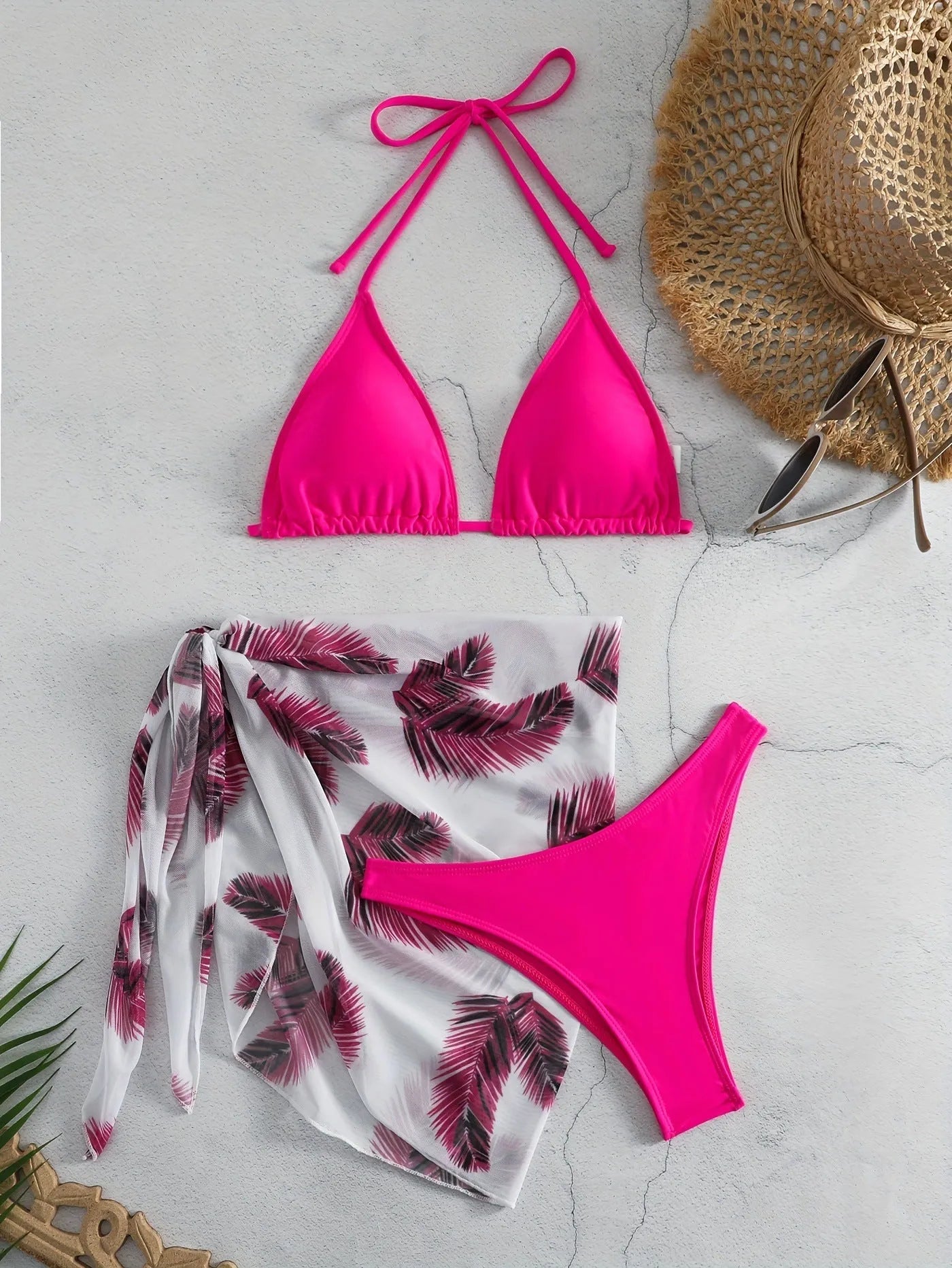 Orange three-piece swimsuit set showing bikini top, bottom, and a loose printed gauze skirt on a mannequin.