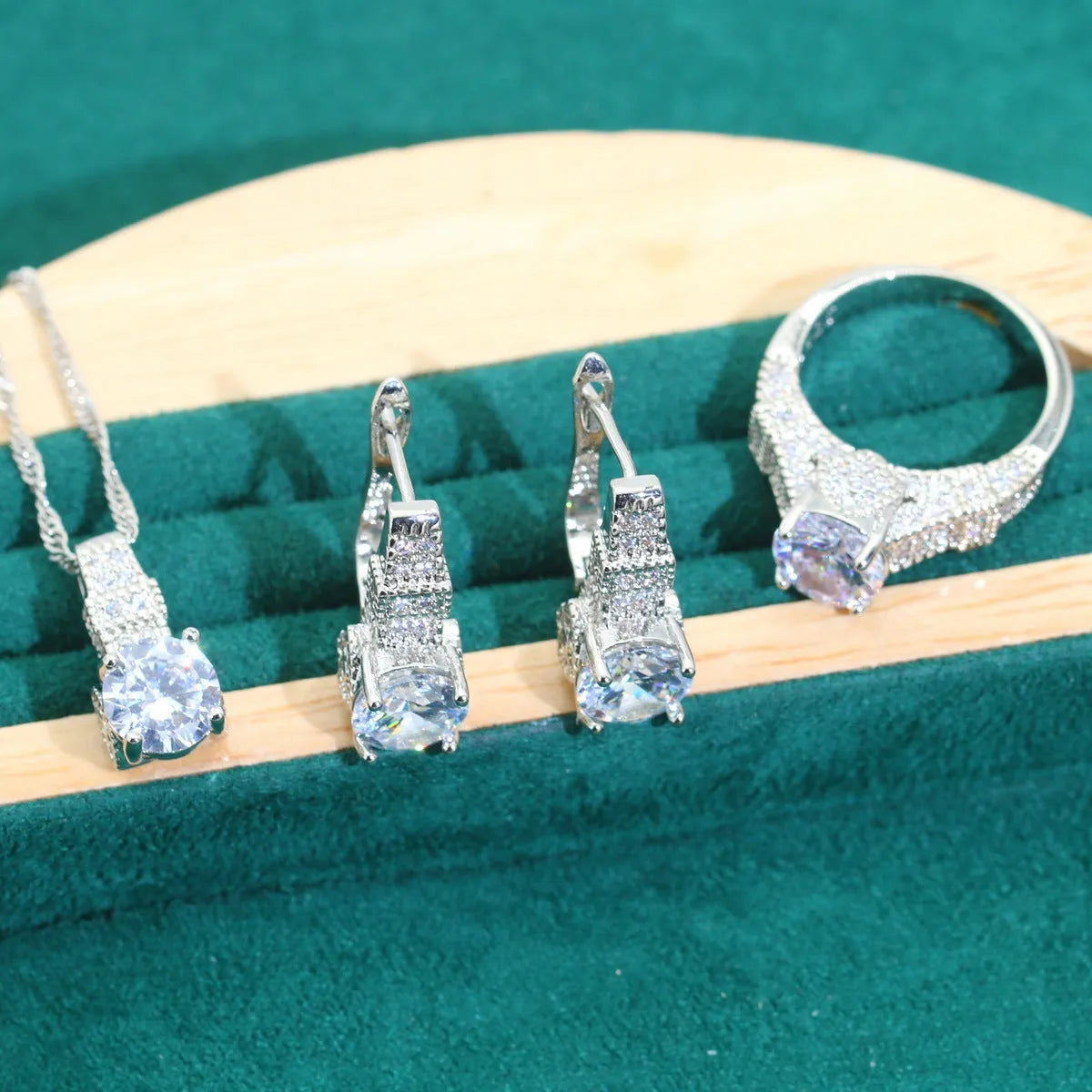 Bridal zircon and alloy four-piece jewellery set showing necklace, earrings, bracelet, and ring in white colour