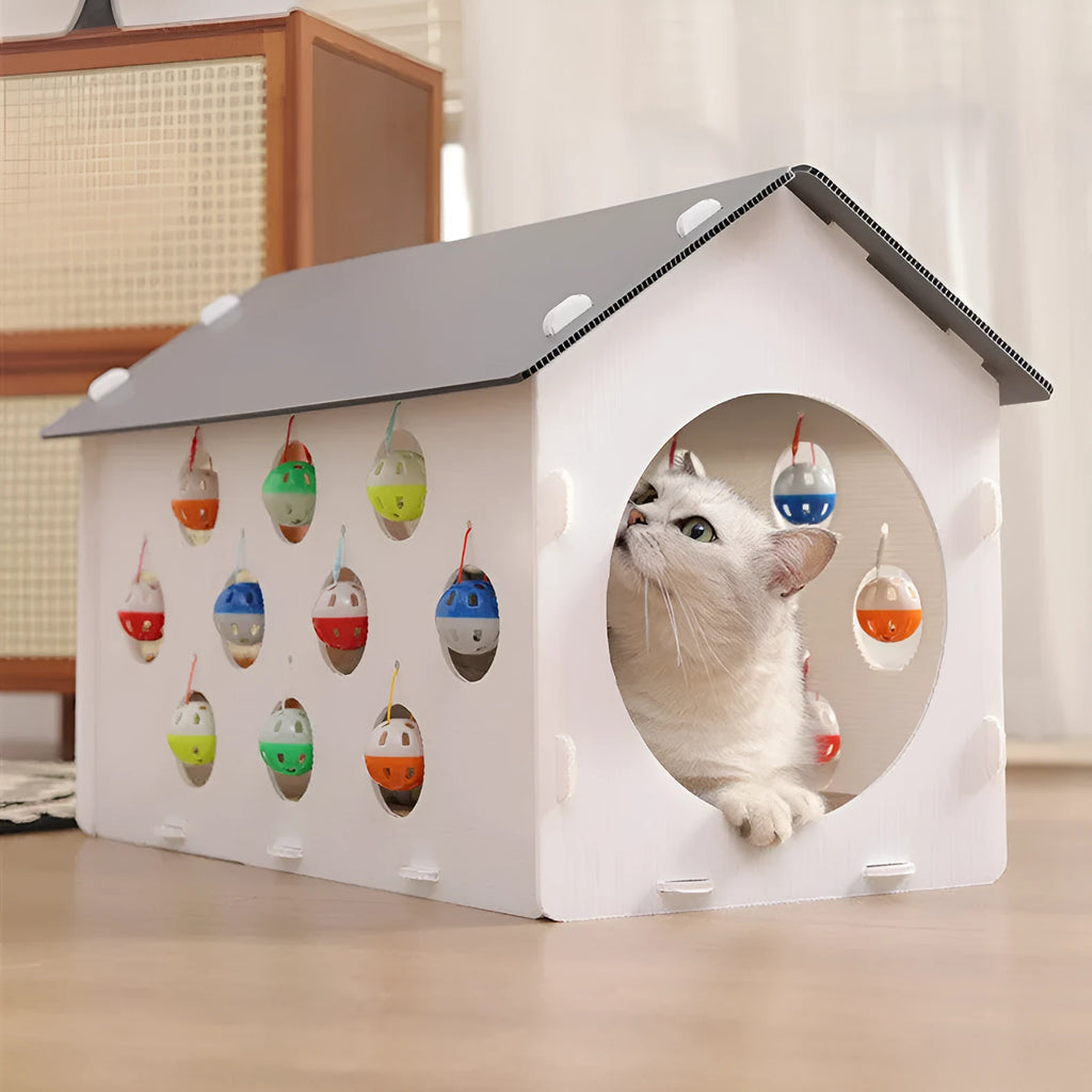 Plastic house-shaped cat scratch board with integrated bell ball toy for feline enrichment