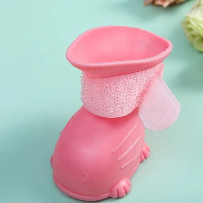 Four waterproof silicone dog rain boots in blue, grey, light blue and pink on a white background