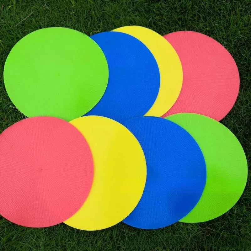 Yellow TPE football training landmark pad, 23cm diameter flat disc on grass.