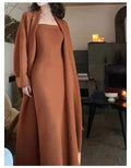 Women's grey knitted cardigan and long skirt two-piece set with flocking detail.