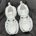 Beige mesh platform sports shoes with a wedge heel and front lace-up fastening.