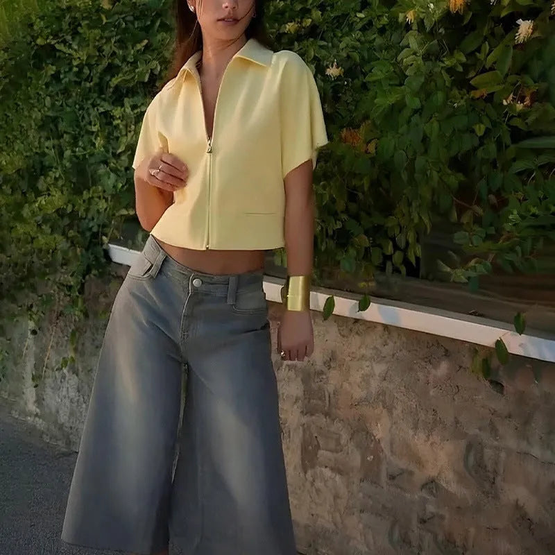 A woman wearing a loose-fit yellow short sleeve casual polyester top.